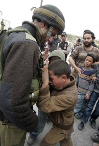 Palestinian boy resisting a soldier